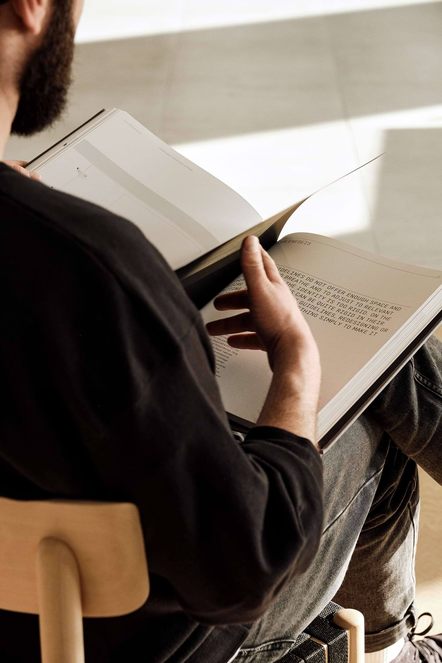 A team member reading a design book in the office